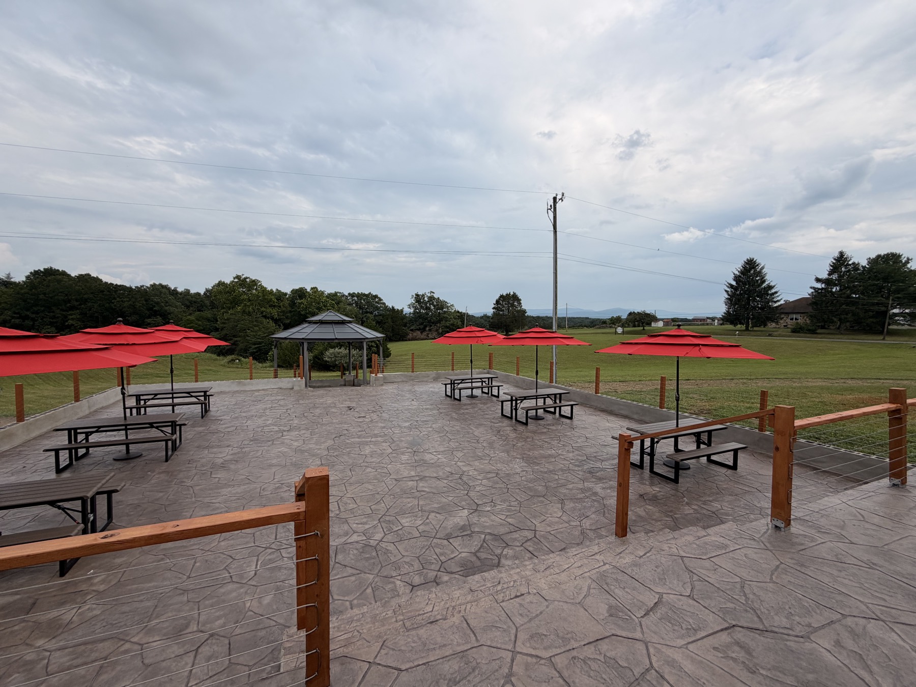 The lower patio looking out over the gazebo, open fields, and the mountains beyond